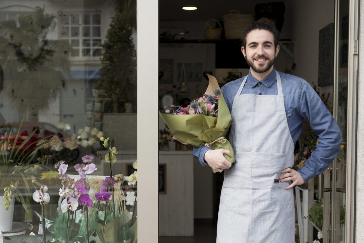 confident-smiling-young-male-florist-standing-entrance-flower-shop-holding-bouquet-hand copy_2
