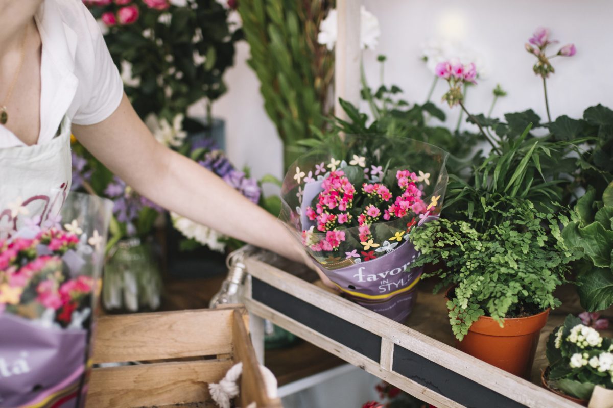 crop-florist-arranging-flowers-shop
